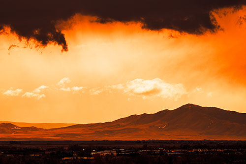 Dark Cloud Mass Above Mountain Range Horizon (Orange Tint Photo)