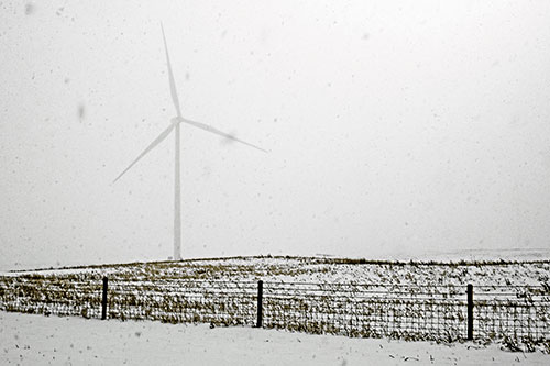 Fenced Wind Turbine Among Blowing Snow (Orange Tint)
