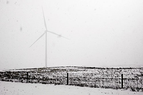 Fenced Wind Turbine Among Blowing Snow (Orange Tint Photo)