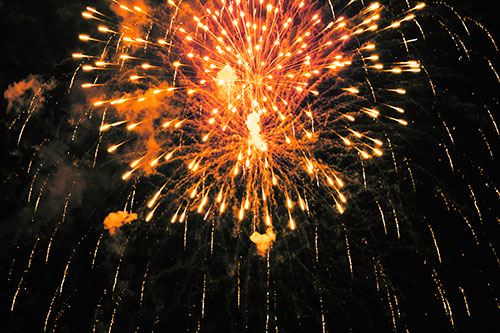 Fireworks Explosion Lights Night Sky Ablaze (Orange Tint Photo)