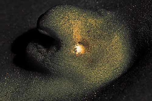 Glowing Eyed Snow Face Emerges Above Soil (Orange Tint)