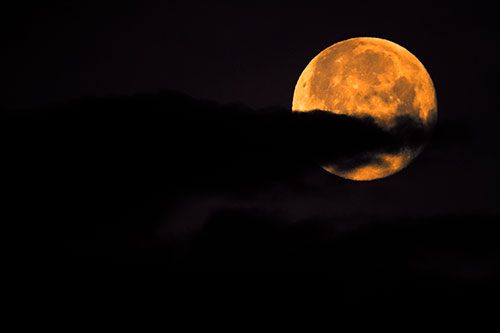 Pac Man Moon Swallows Clouds (Orange Tint Photo)