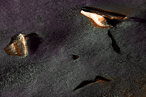 Sad Teardrop Ice Face Appears Atop Frozen River (Orange Tint Photo)