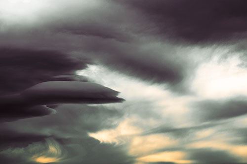 Smooth Cloud Sails Along Swirling Formations (Orange Tint Photo)