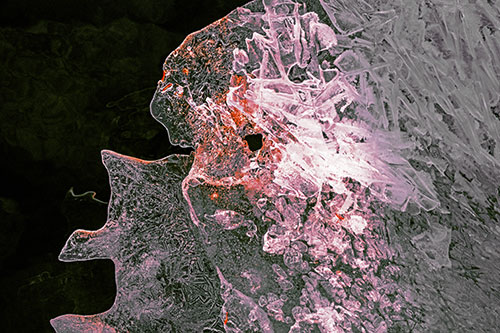 Two Faced Optical Illusion Ice Face Hanging Above River (Orange Tint)