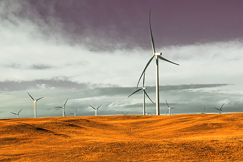 Wind Turbine Cluster Overtaking Hilly Horizon (Orange Tint Photo)