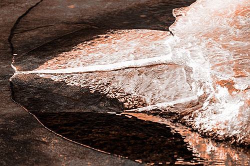 Abstract Ice Sculpture Forms Atop Frozen River (Orange Tone Photo)