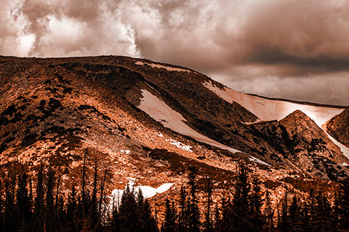 Clouds Cover Melted Snowy Mountain Range (Orange Tone Photo)