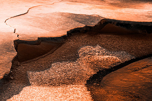 Cracked Ice Frozen Shoreline Melting (Orange Tone Photo)