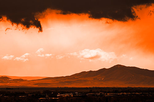 Dark Cloud Mass Above Mountain Range Horizon (Orange Tone Photo)