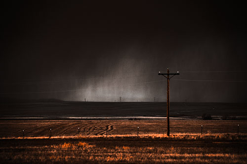 Distant Thunderstorm Rains Down Upon Powerlines (Orange Tone Photo)