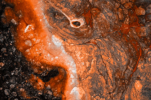 Distressed Oil Face Swirling Among Rocky Shore (Orange Tone)