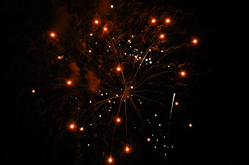 Firework Light Orbs Free Falling After Explosion (Orange Tone Photo)