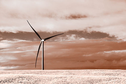 Lone Wind Turbine Standing Along Dry Prairie Horizon (Orange Tone Photo)