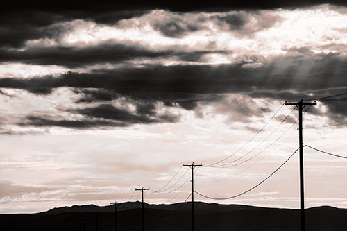 Powerline Silhouette Entering Mountain Range (Orange Tone Photo)