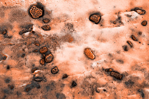 Rocks Forming Smiley Face Atop Snow (Orange Tone Photo)