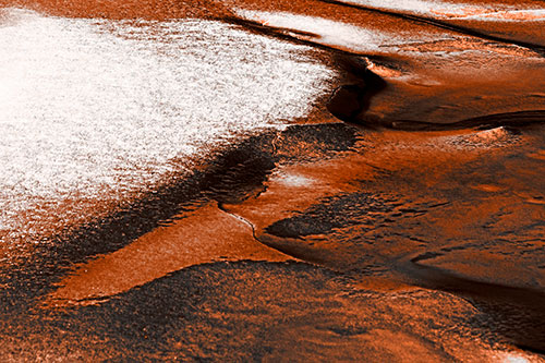 Sloping Ice Melting Atop River Water (Orange Tone Photo)