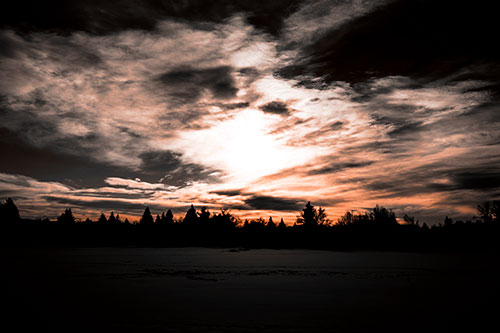 Sun Vortex Illuminates Clouds Above Dark Lit Lake (Orange Tone Photo)