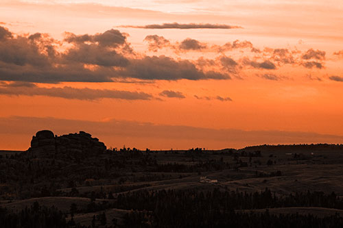Sunrise Over Rock Formations On The Horizon (Orange Tone Photo)