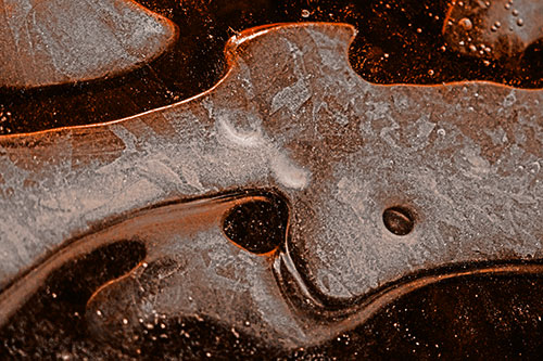 Swirling Frozen Smiling Bubble Eyed River Ice Face (Orange Tone)