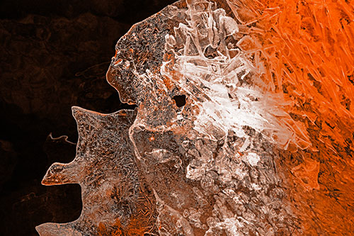 Two Faced Optical Illusion Ice Face Hanging Above River (Orange Tone Photo)
