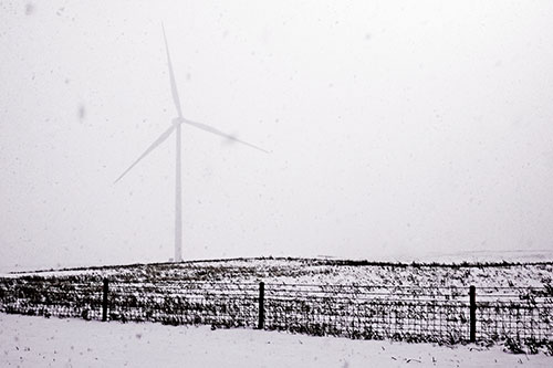 Fenced Wind Turbine Among Blowing Snow (Pink Tint Photo)