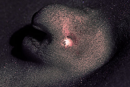 Glowing Eyed Snow Face Emerges Above Soil (Pink Tint)