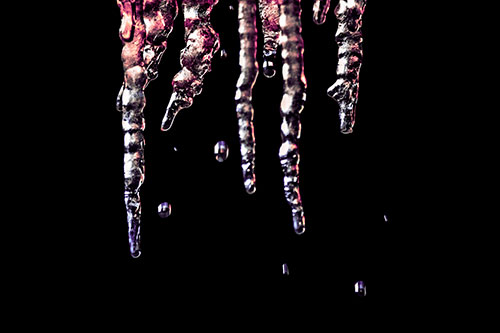 Jagged Melting Icicles Dripping Water (Pink Tint Photo)