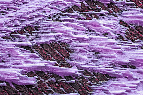 Snow Drifts Atop Rigid Pavement (Pink Tint Photo)