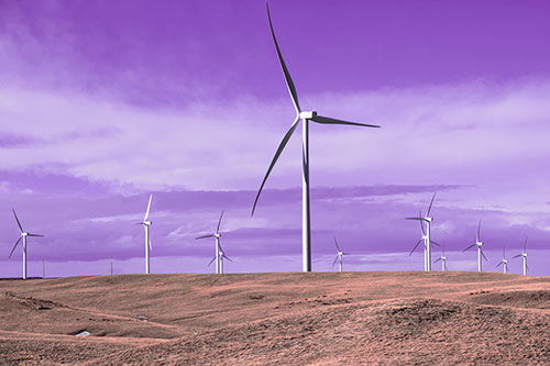 Wind Turbine Cluster Scattered Across Land (Pink Tint Photo)