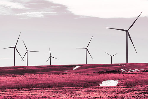 Wind Turbines Scattered Around Melting Snow Patches (Pink Tint Photo)
