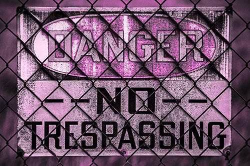 Dirty Danger No Trespassing Sign Behind Chain Link Fence (Pink Tone)