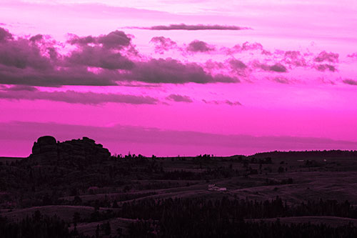 Sunrise Over Rock Formations On The Horizon (Pink Tone Photo)