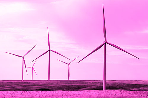Wind Turbines Standing Tall On Green Pasture (Pink Tone Photo)