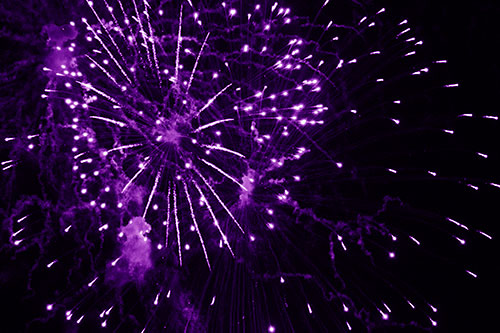 Multiple Firework Explosions Send Light Orbs Flying (Purple Shade Photo)