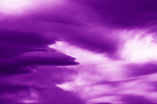 Smooth Cloud Sails Along Swirling Formations (Purple Shade Photo)