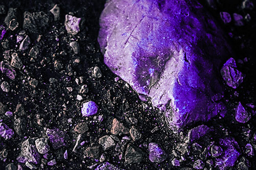 Alien Skull Rock Face Emerging Atop Dirt Surface (Purple Tint Photo)