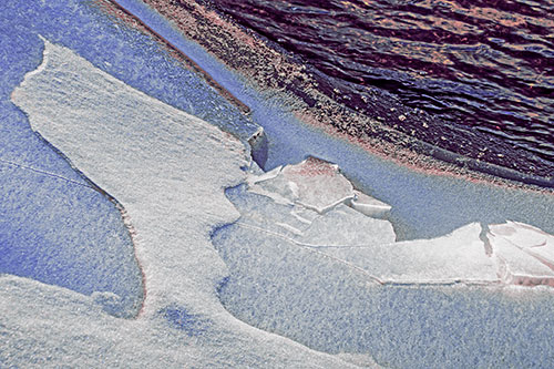 Broken Cracked Ice Along Shoreline (Purple Tint Photo)