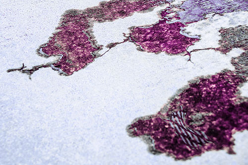 Creeping Water Puddle Across Concrete Pavement (Purple Tint)