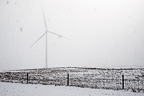Fenced Wind Turbine Among Blowing Snow (Purple Tint)