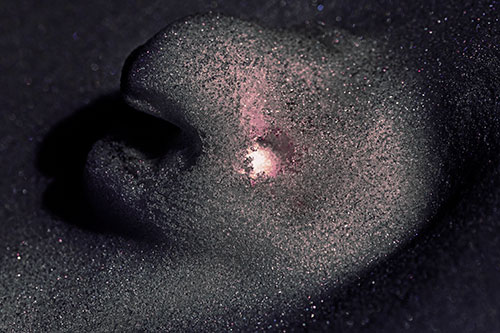 Glowing Eyed Snow Face Emerges Above Soil (Purple Tint)