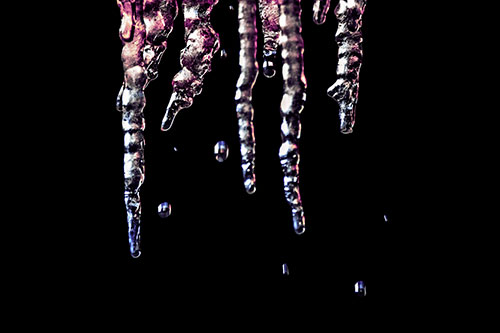 Jagged Melting Icicles Dripping Water (Purple Tint Photo)