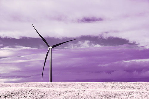 Lone Wind Turbine Standing Along Dry Prairie Horizon (Purple Tint Photo)