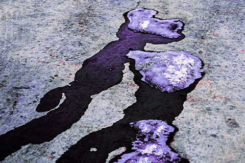 Melting Ice Puddles Forming Water Streams (Purple Tint Photo)