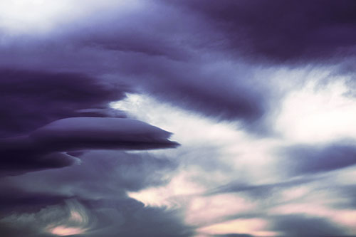 Smooth Cloud Sails Along Swirling Formations (Purple Tint Photo)