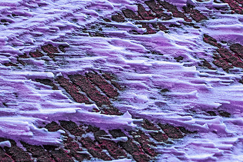 Snow Drifts Atop Rigid Pavement (Purple Tint Photo)