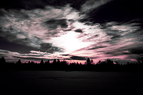Sun Vortex Illuminates Clouds Above Dark Lit Lake (Purple Tint Photo)