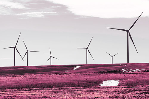 Wind Turbines Scattered Around Melting Snow Patches (Purple Tint Photo)