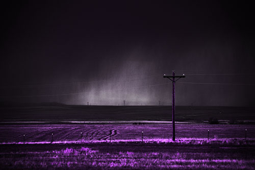 Distant Thunderstorm Rains Down Upon Powerlines (Purple Tone Photo)
