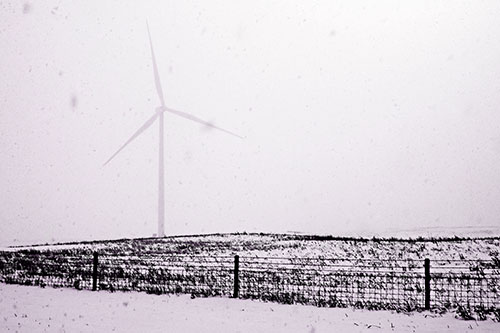 Fenced Wind Turbine Among Blowing Snow (Purple Tone Photo)